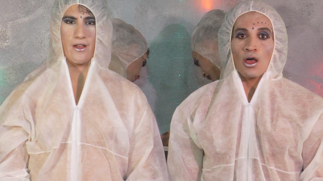 Still from Changing Direction: two characters in white protective suits