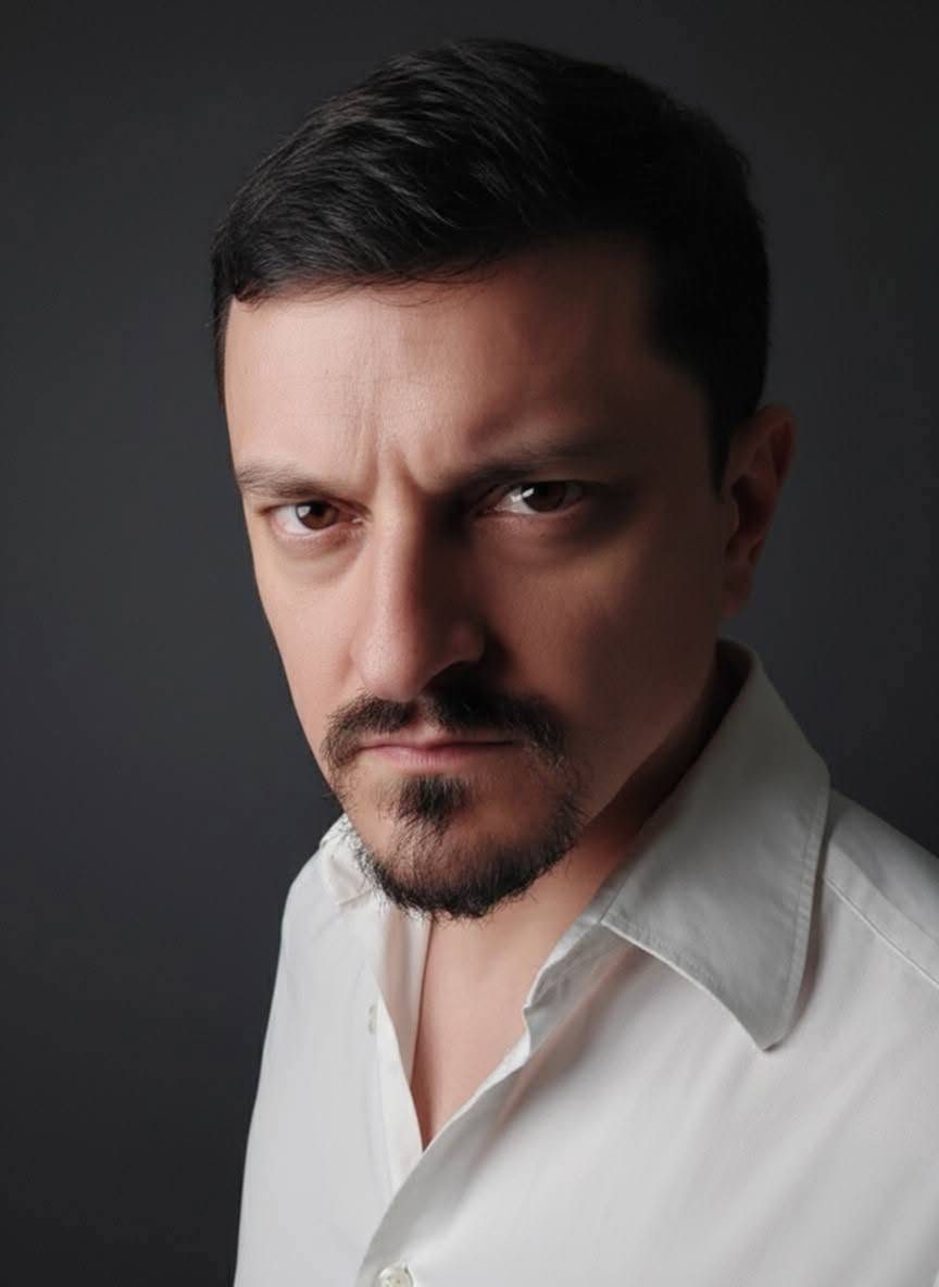 Kuya Manzano, founder of iChill Productions, intense look in a white shirt against a dark background